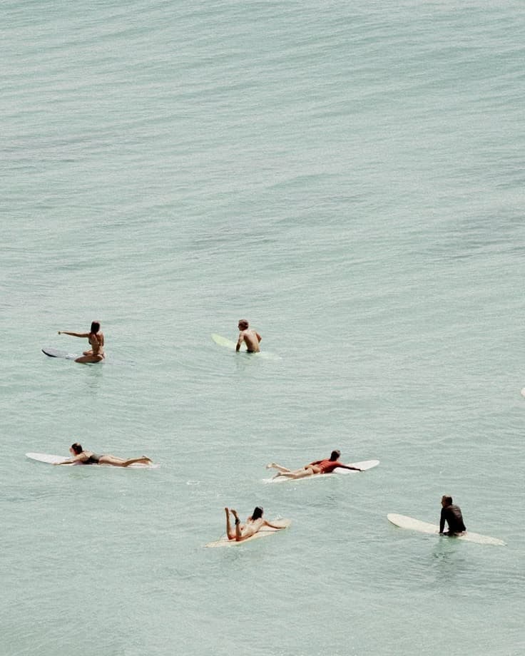 Ocean waves crashing on rocky coastline with clear blue sky